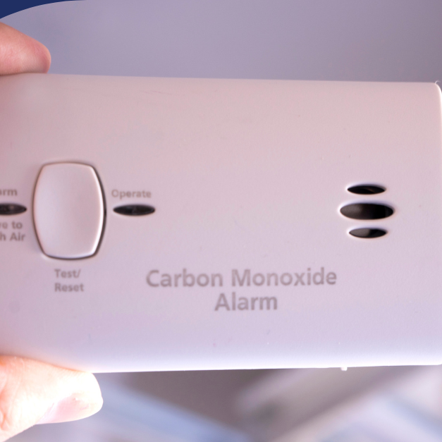 Hand holding a carbon monoxide alarm