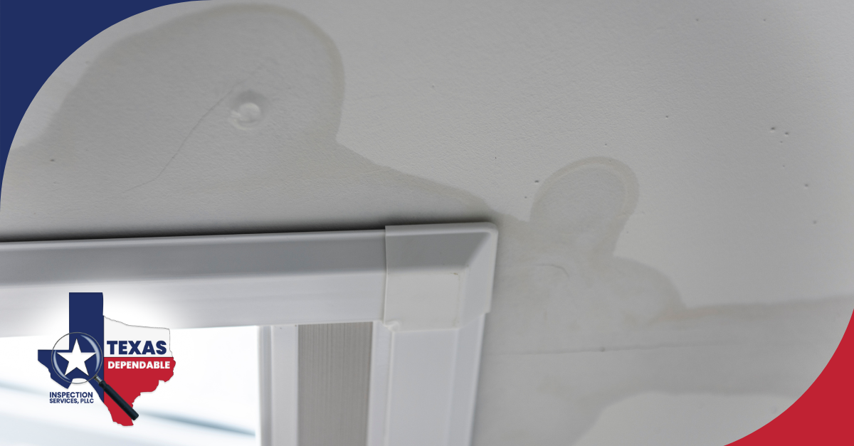 Ceiling water stain and bubbling above a window frame indicating a potential leak.